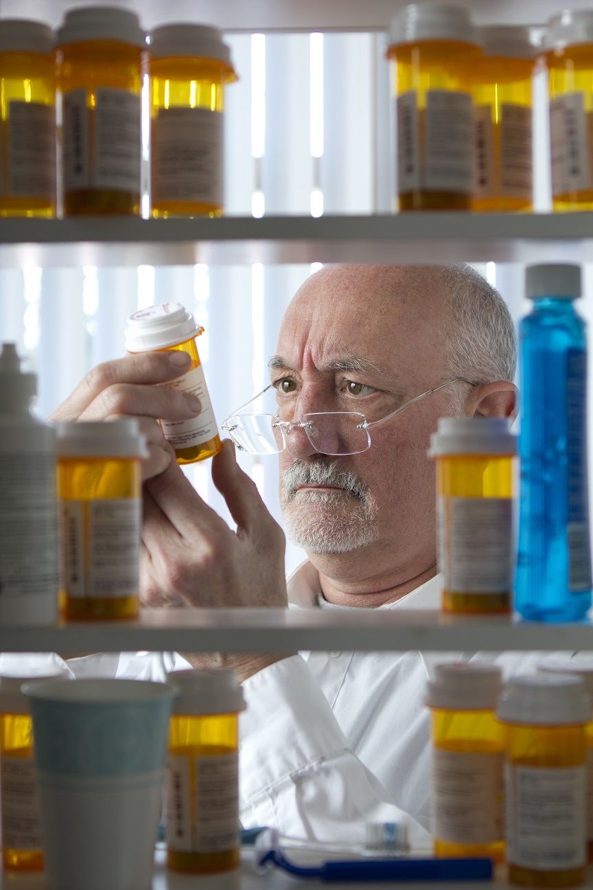 Man reaching for prescription form medicine cabinet