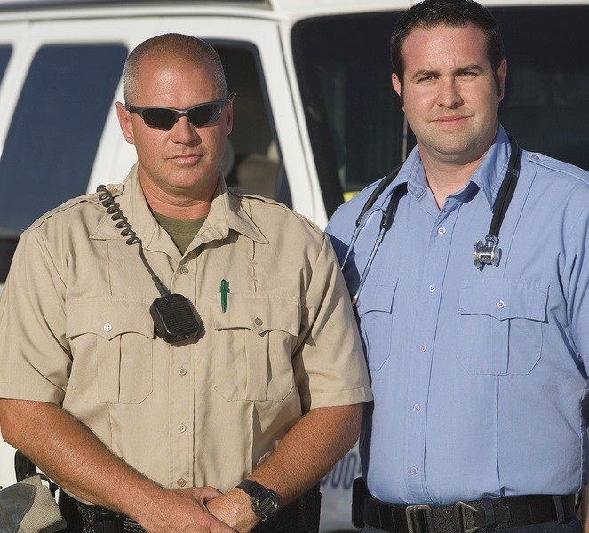 Portrait of a firefighter, traffic cop and EMT doctor standing together