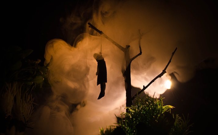 Horror view of hanged girl on tree at evening (at night)