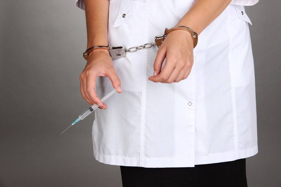 Doctor-with-syringe-in-handcuffs