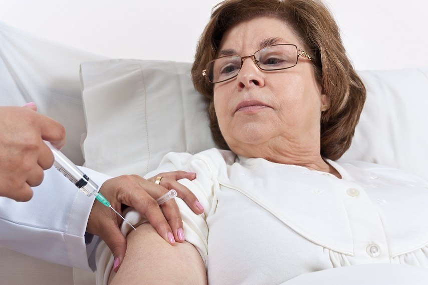 Doctor giving injection to Senior Patient