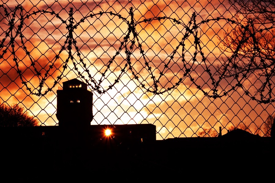 Sun in the orange sky setting over prison yard