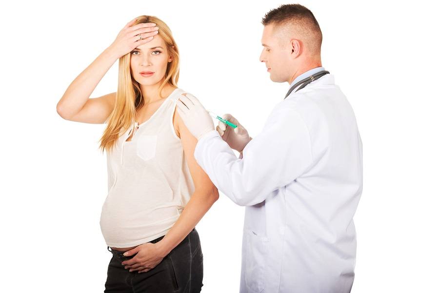 Pregnant woman getting vaccine from her gynecologist