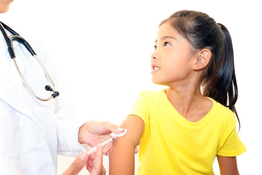 Doctor injecting child vaccine isolated on white background