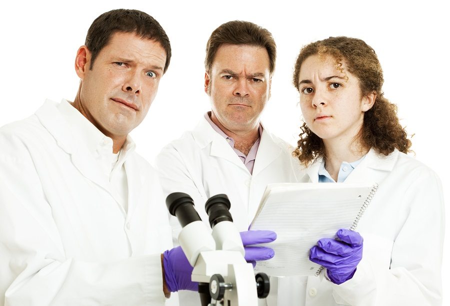 Perplexed confused scientists looking at lab results. White background.