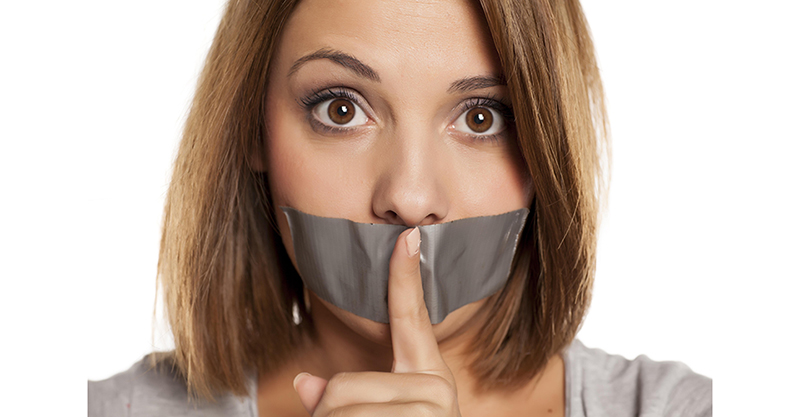 angry young woman with adhesive tape over her mouth, and finger