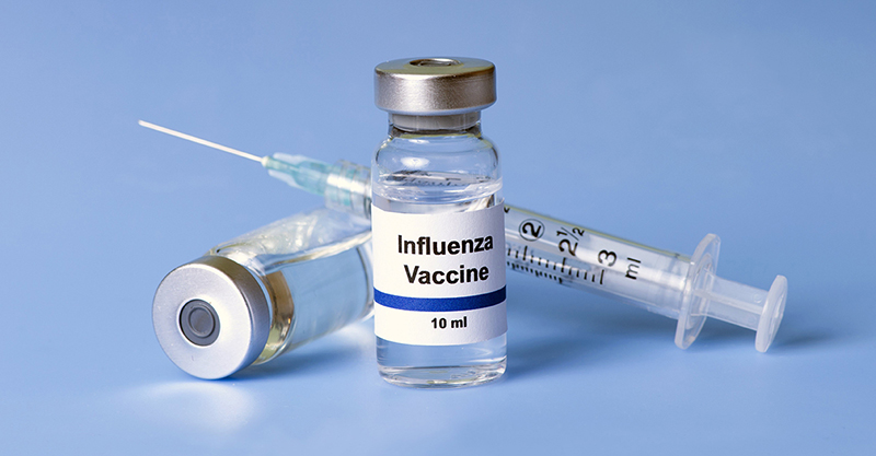 Influenza vaccine, syringe, and vials.