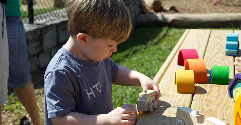 child boy playing Nature Explore Outdoor Classroom