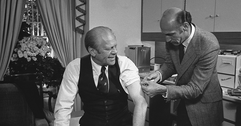 President Ford receives a swine flu inoculation from his White House physician, Dr. William Lukash.