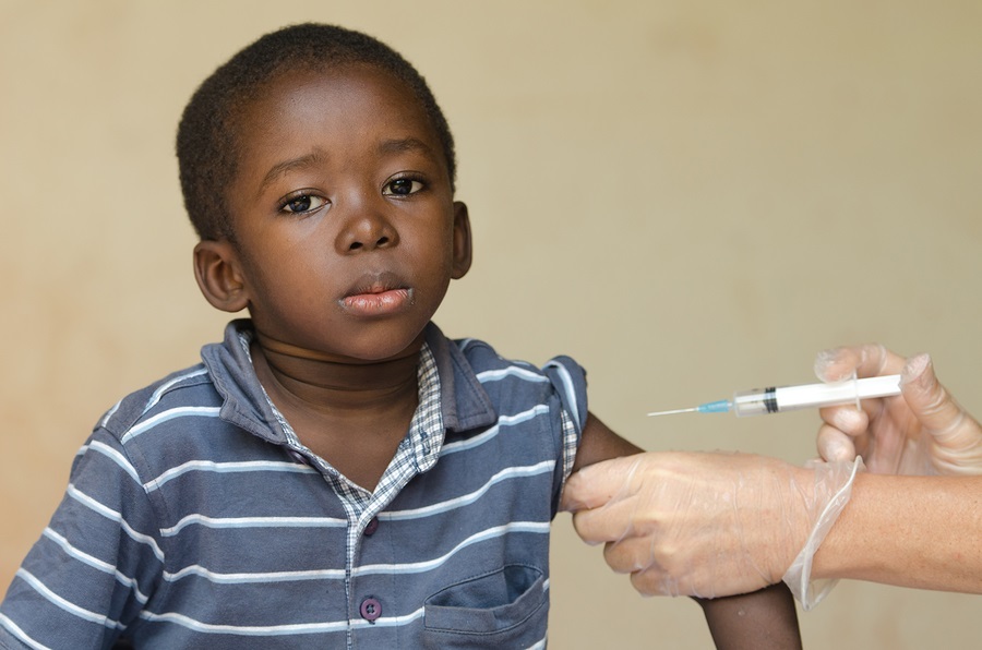 Close-up of a little black African ethnicity boy getting a medical injection as a vaccination. 