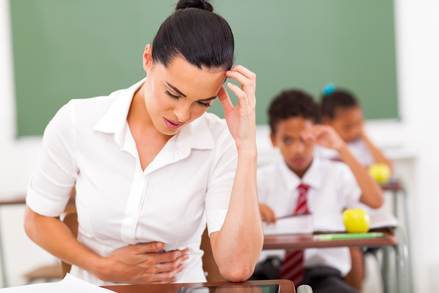 elementary school female teacher feeling sick in classroom